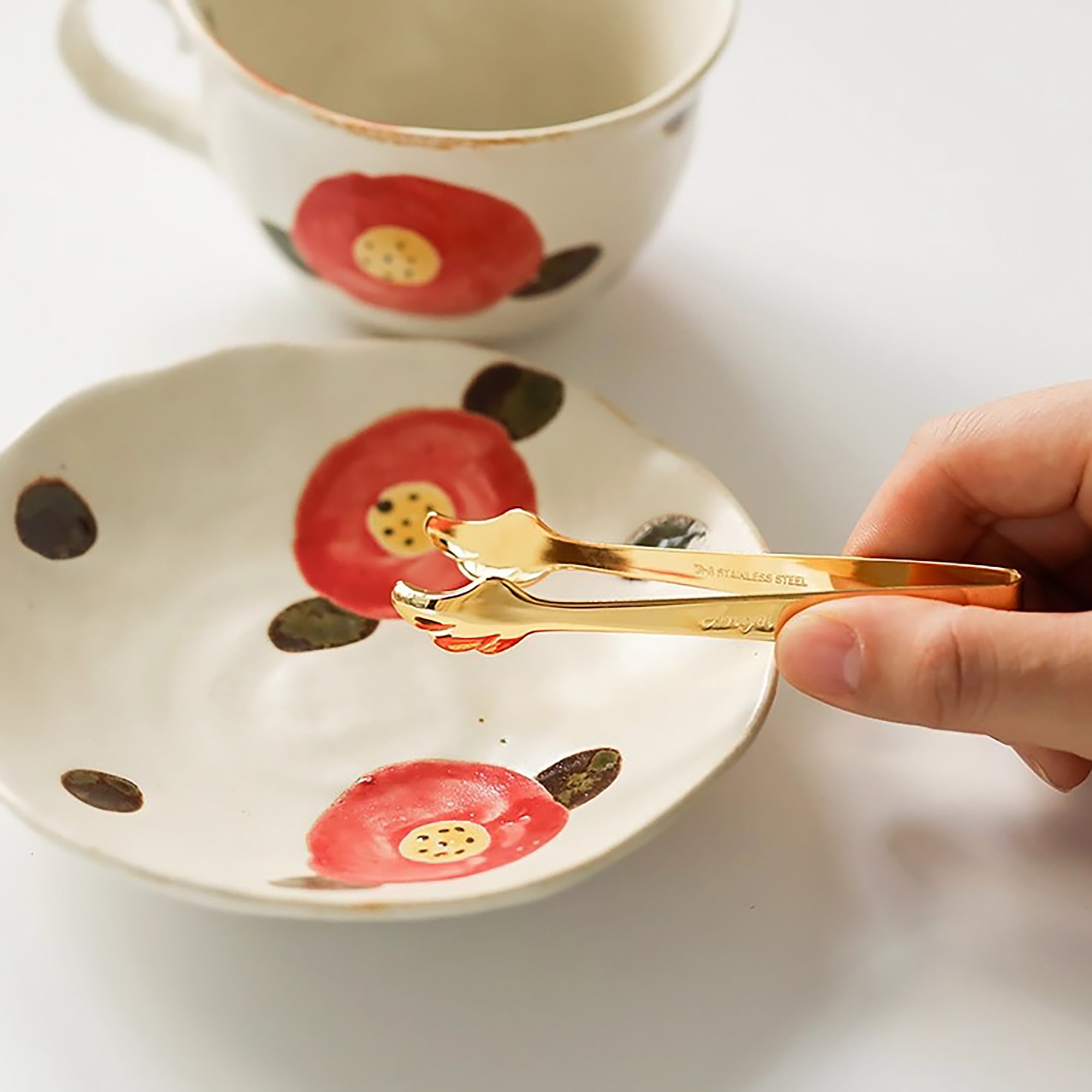 Pince dorée Takakuwa en acier avec motif aile d’ange